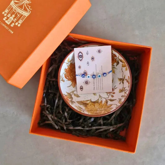 Premium Rakhi Gift Hamper with Evil Eye Rakhi & Lumba, Set of 2 Handcrafted Stoneware Bowls & Greeting Card | Luxury Raksha Bandhan Gift Box for Bhai & Bhabhi The Confetti Tree