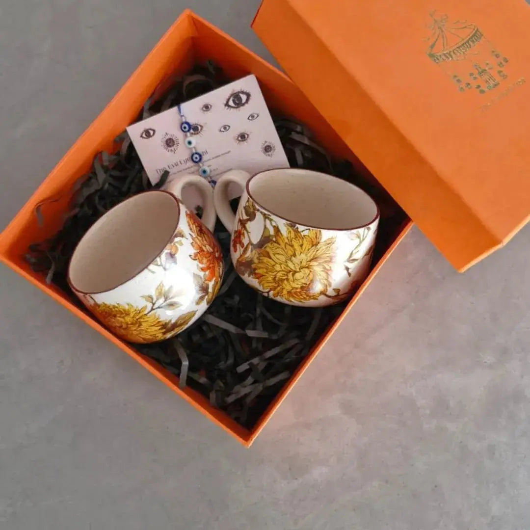 Premium Rakhi Gift Hamper with Evil Eye Rakhi & Lumba, Set of 2 Summer Orchard Ceramic Cappuccino Cups & Greeting Card | Luxury Raksha Bandhan Gift Box for Bhai & Bhabhi The confetti tree