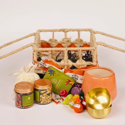 Eco-Friendly Growth Inspired Gift Hamper with Ceramic Planter, Brass Diyas, Seed Balls, Mukhwas & Dry Fruits, Plantable Crackers & Playing Cards The confetti tree