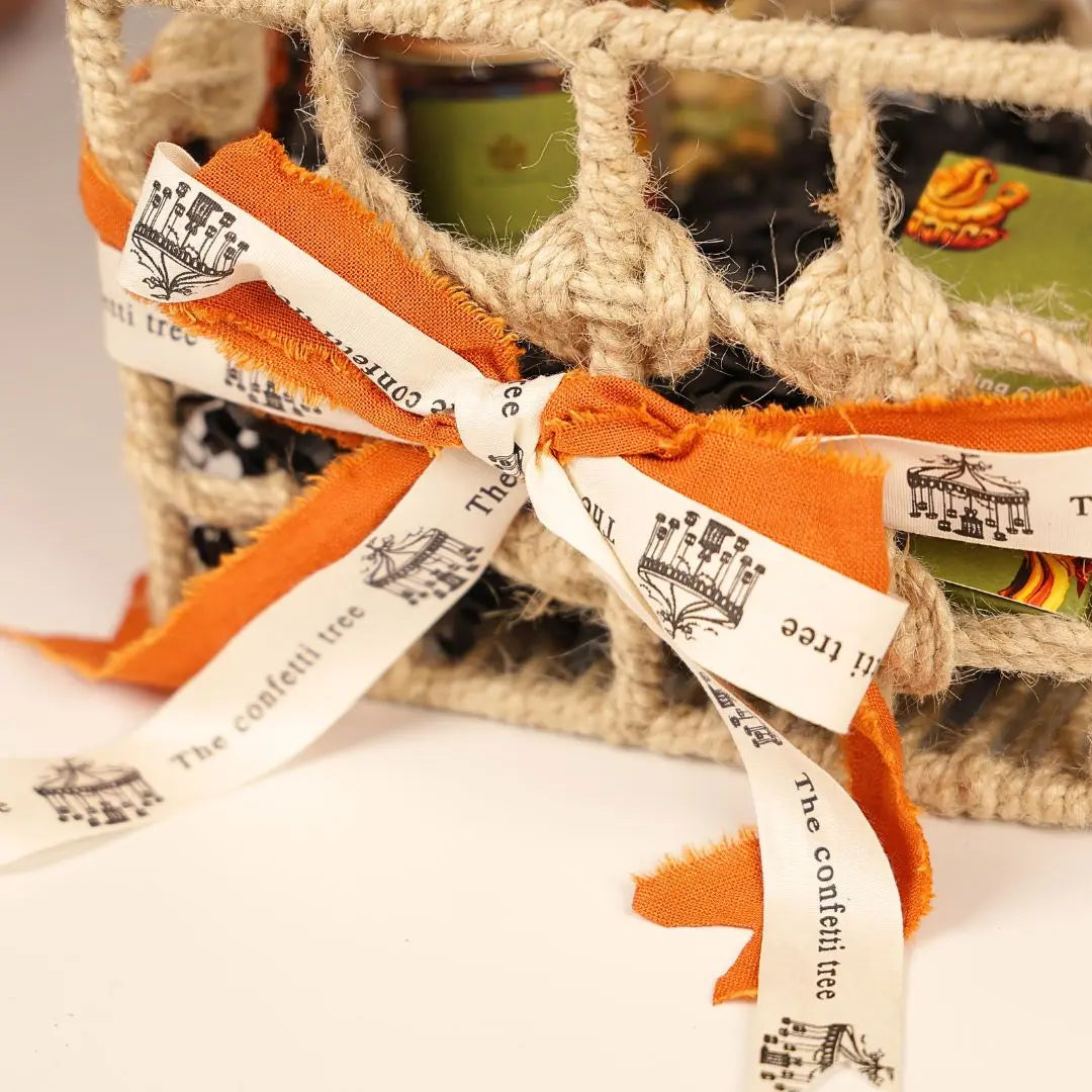 Eco-Friendly Soil Inspired Gift Hamper with Jute Basket, Terracotta Jar of Cashews, Marble Urli, Toran, Playing Cards, Terracotta Candle & Plantable Ganesh The confetti tree