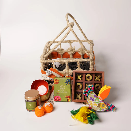 Luxury Jute Gift Basket with Wooden Tic Tac Toe, Brass Diyas, Toran, Laddoo Candles, Mukhwas Jar & Playing Cards – Festive Gifting Hamper The confetti tree