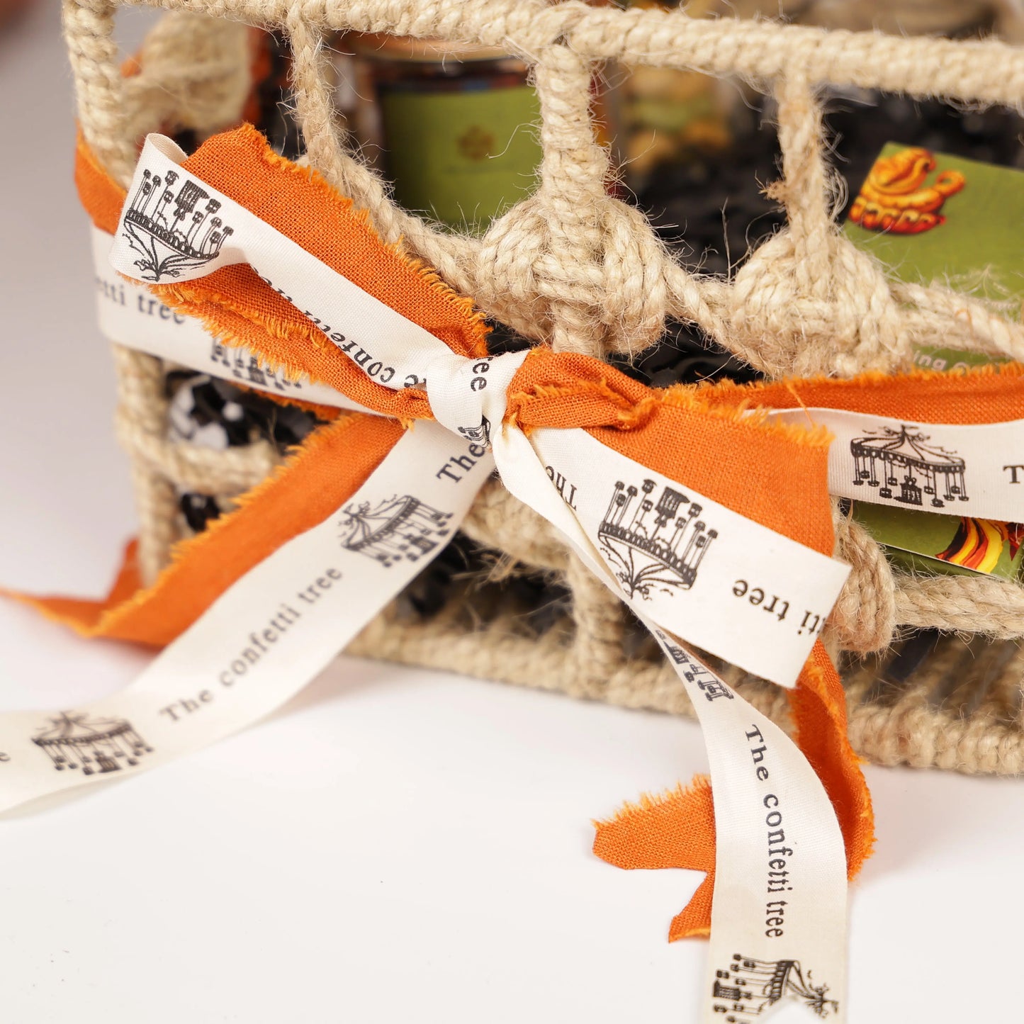 Luxury Jute Gift Basket with Wooden Tic Tac Toe, Brass Diyas, Toran, Laddoo Candles, Mukhwas Jar & Playing Cards – Festive Gifting Hamper The confetti tree