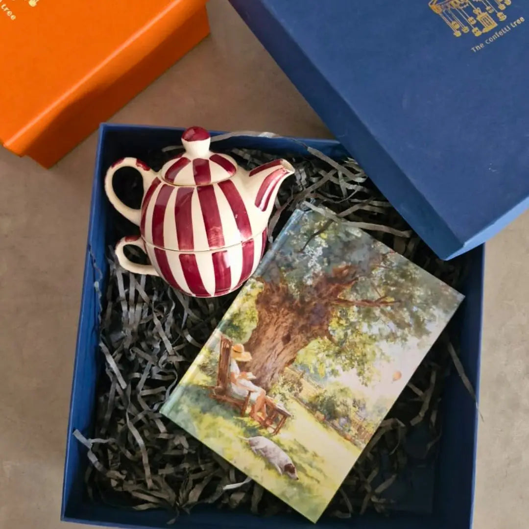 Luxury Rakhi Gift Hamper with Evil Eye Rakhi & Lumba, Handpainted Stoneware Teapot & Cup Set, Hardbound Lazy Day Musings Notebook & Greeting Card | Premium Raksha Bandhan Gift Box for Bhai & Bhabhi The confetti tree