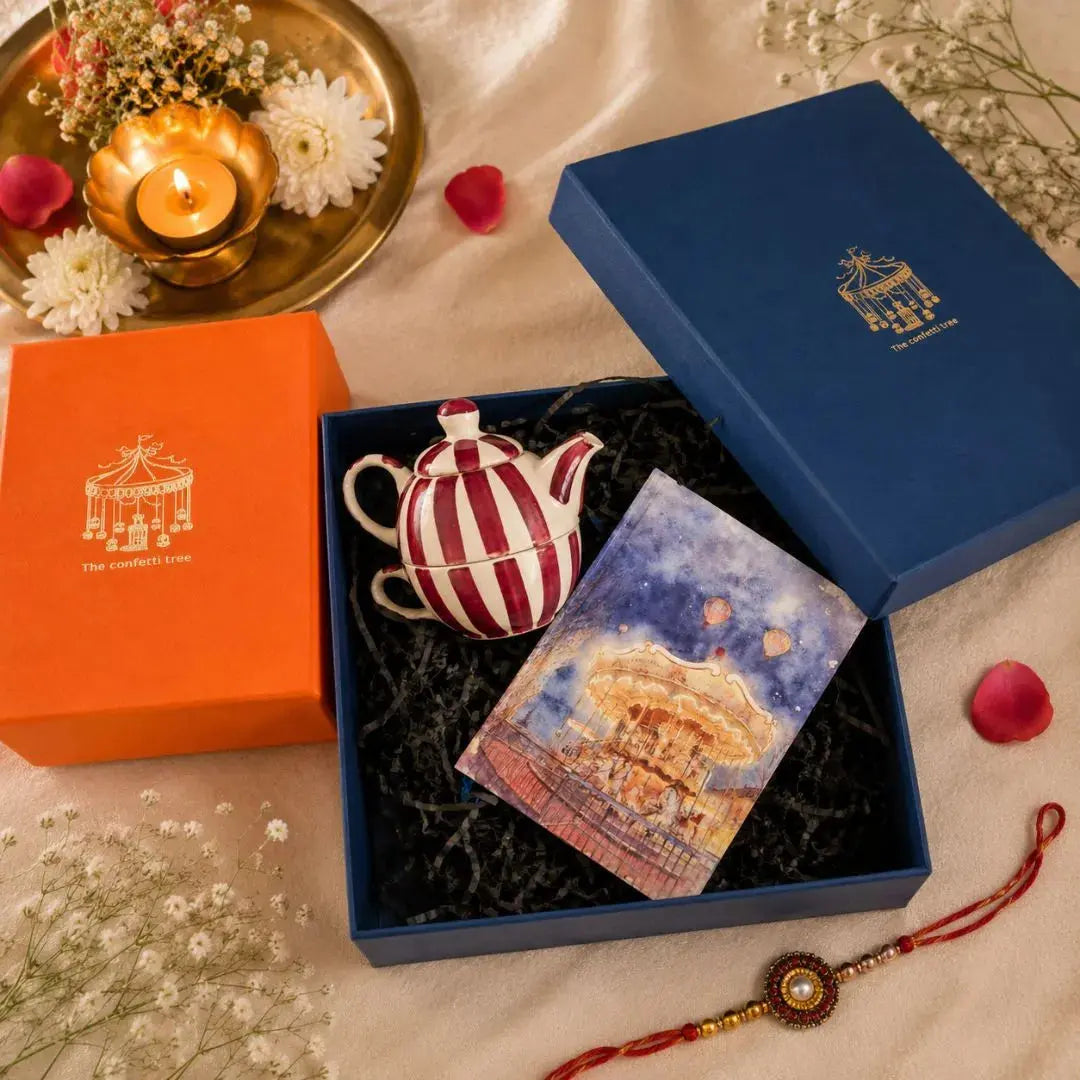 Luxury Rakhi Gift Hamper with Evil Eye Rakhi & Lumba, Handpainted Stoneware Teapot & Cup Set, Hardbound Night Circus Notebook & Greeting Card | Premium Raksha Bandhan Gift Box for Bhai & Bhabhi The confetti tree