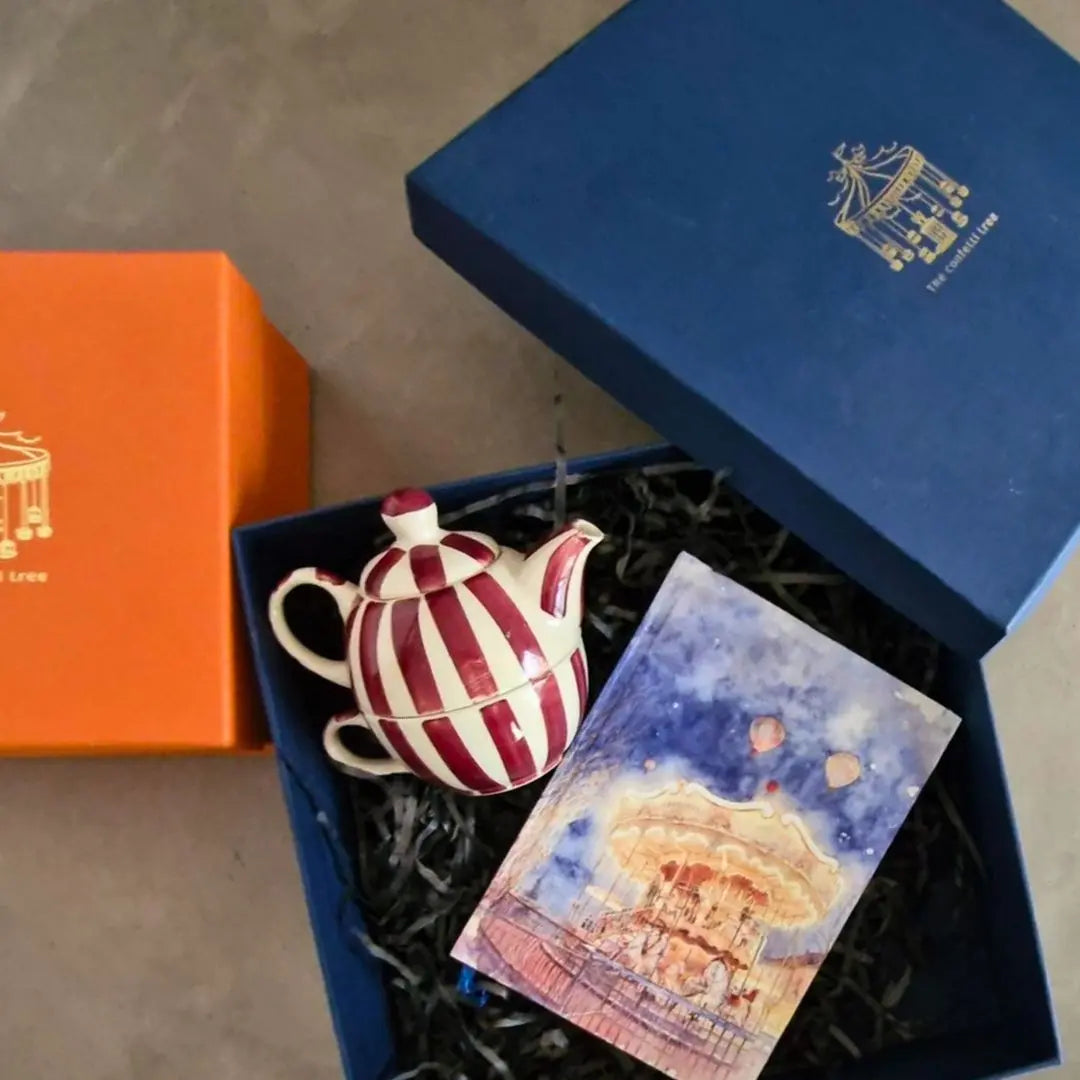 Luxury Rakhi Gift Hamper with Evil Eye Rakhi & Lumba, Handpainted Stoneware Teapot & Cup Set, Hardbound Night Circus Notebook & Greeting Card | Premium Raksha Bandhan Gift Box for Bhai & Bhabhi The confetti tree