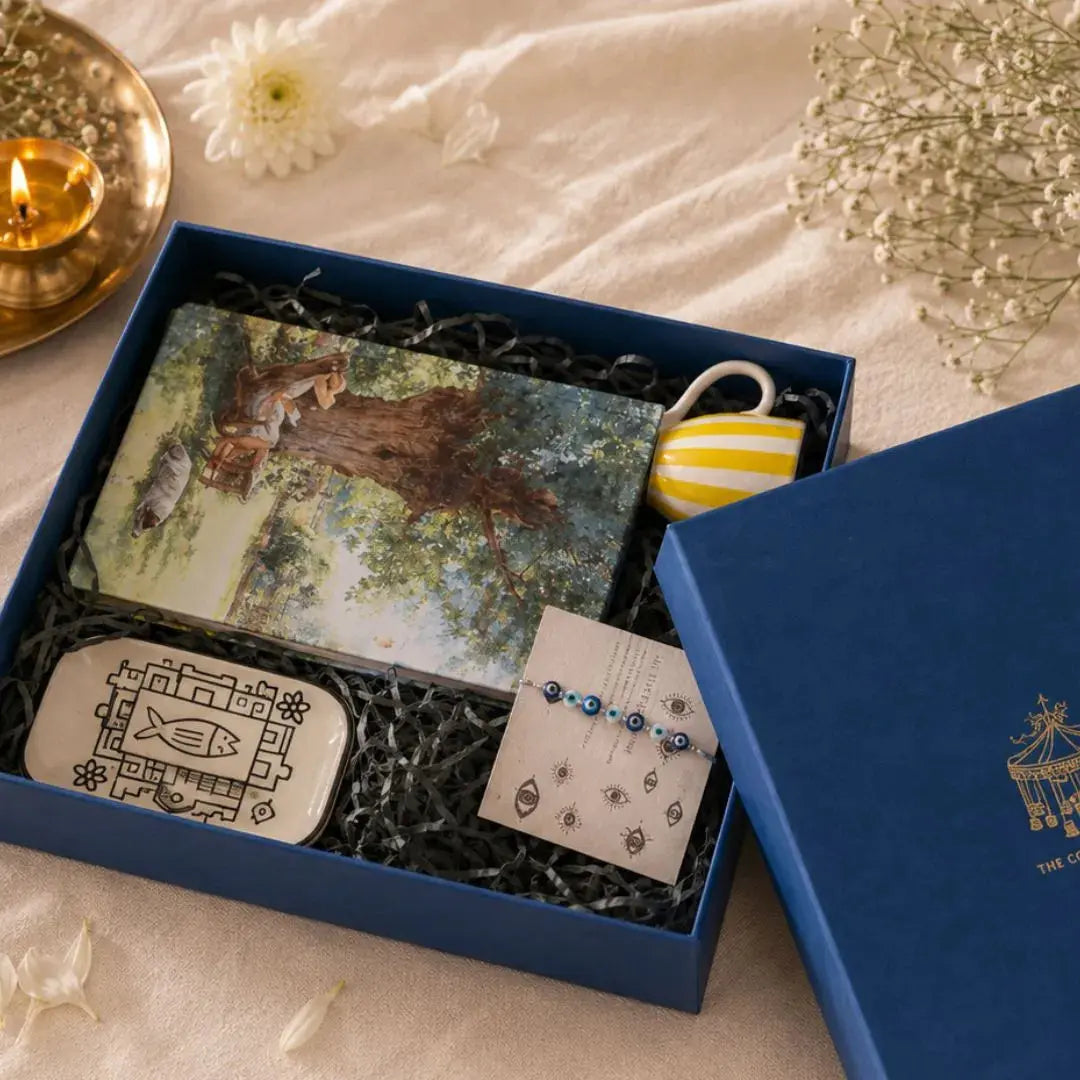 Luxury Rakhi Gift Hamper with Evil Eye Rakhi & Lumba, Hardbound Notebook, Fish Ceramic Trinket Tray, Stoneware Coffee Mug & Greeting Card | Premium Raksha Bandhan Gift Box for Bhai & Bhabhi The confetti tree