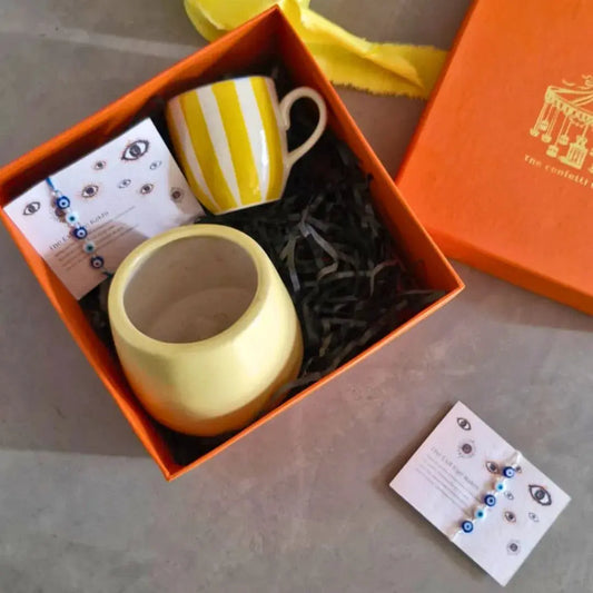 Premium Rakhi Gift Hamper with Evil Eye Rakhi & Lumba, Ceramic Planter, Stoneware Coffee Mug & Greeting Card | Luxury Raksha Bandhan Gift Box for Bhai & Bhabhi The confetti tree