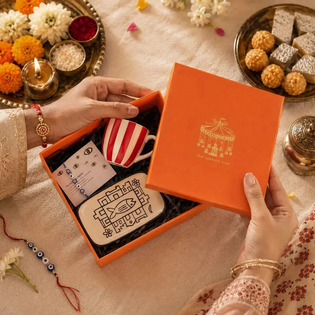 Premium Rakhi Gift Hamper with Evil Eye Rakhi & Lumba, Ceramic Trinket Tray, Stoneware Coffee Mug & Greeting Card | Luxury Raksha Bandhan Gift Box for Bhai & Bhabhi The confetti tree