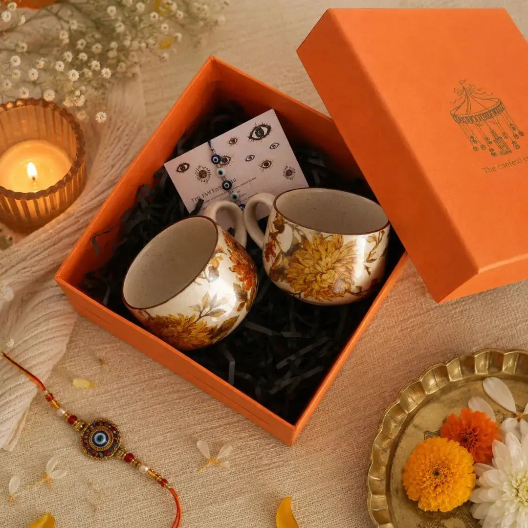 Premium Rakhi Gift Hamper with Evil Eye Rakhi & Lumba, Set of 2 Summer Orchard Ceramic Cappuccino Cups & Greeting Card | Luxury Raksha Bandhan Gift Box for Bhai & Bhabhi The confetti tree
