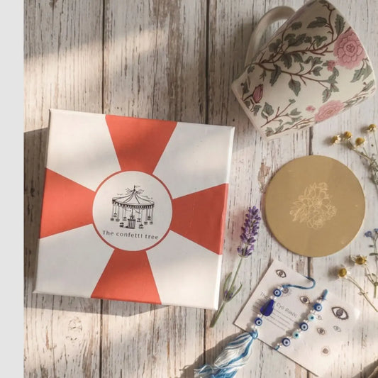 Rakhi Gift Hamper with Evil Eye Rakhi & Lumba, Floral Ceramic Mug & Pure Brass Coaster | Premium Raksha Bandhan Gift Box for Bhai Bhabhi The confetti tree