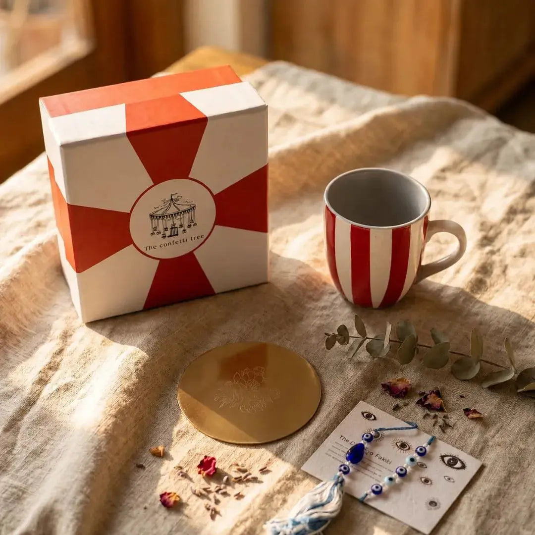 Rakhi Gift Hamper with Evil Eye Rakhi & Lumba, Handpainted Red Striped Ceramic Mug & Pure Brass Coaster | Premium Raksha Bandhan Gift Box for Bhai Bhabhi The confetti tree