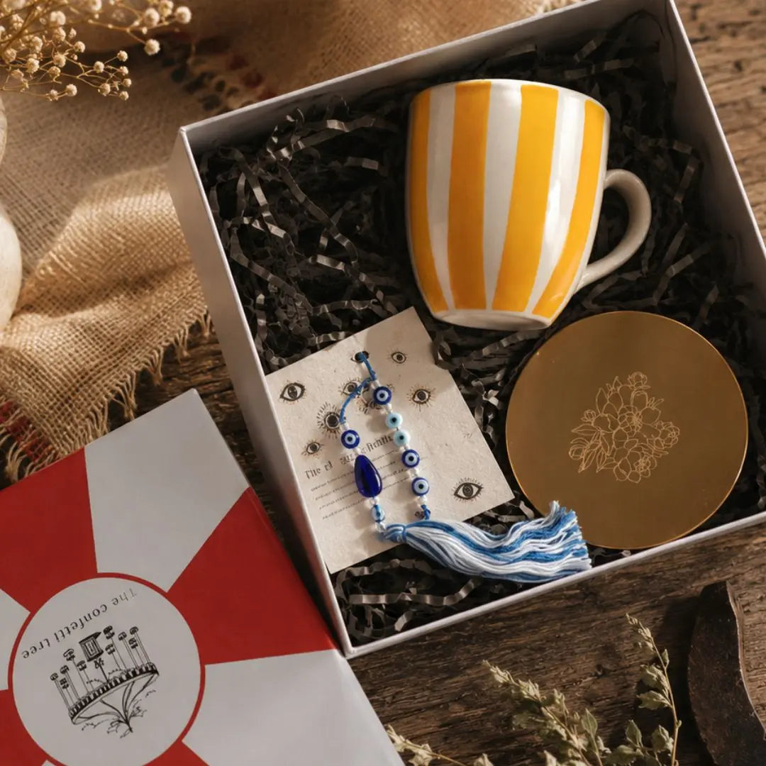 Rakhi Gift Hamper with Evil Eye Rakhi & Lumba, Handpainted Yellow Striped Ceramic Mug & Pure Brass Coaster | Premium Raksha Bandhan Gift Box for Bhai Bhabhi The confetti tree