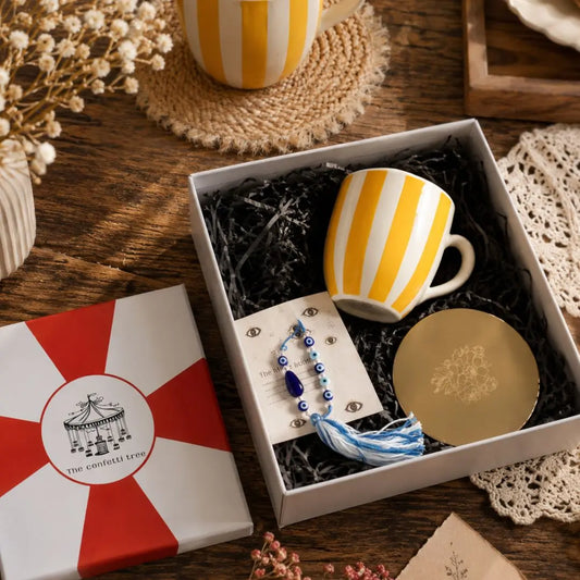 Rakhi Gift Hamper with Evil Eye Rakhi & Lumba, Handpainted Yellow Striped Ceramic Mug & Pure Brass Coaster | Premium Raksha Bandhan Gift Box for Bhai Bhabhi The confetti tree