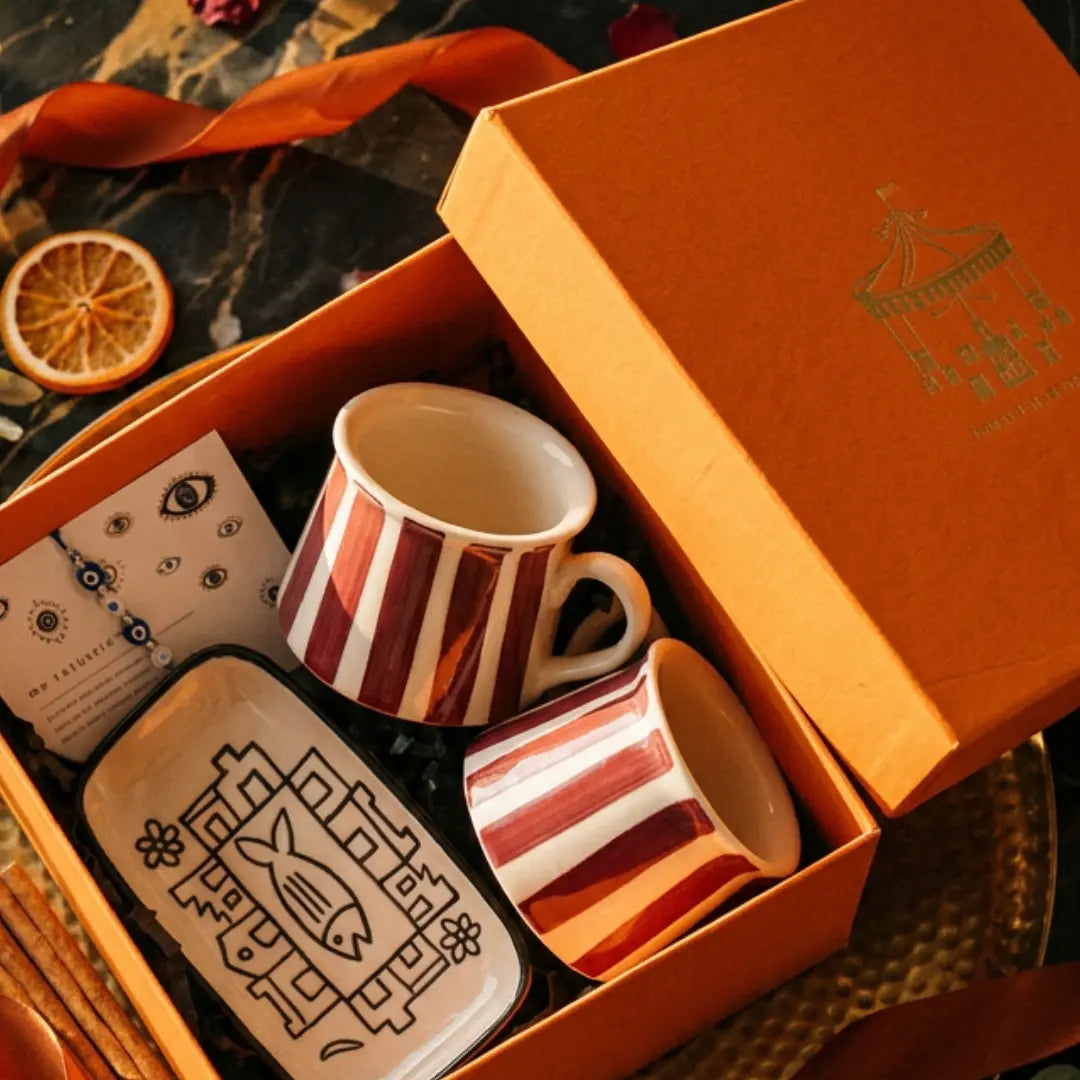 Rakhi Gift Hamper with Evil Eye Rakhi & Lumba, Set of 2 Handpainted Maroon Matka Tea Cups & Hand-Illustrated Trinket Tray | Premium Raksha Bandhan Gift for Bhai Bhabhi The Confetti Tree