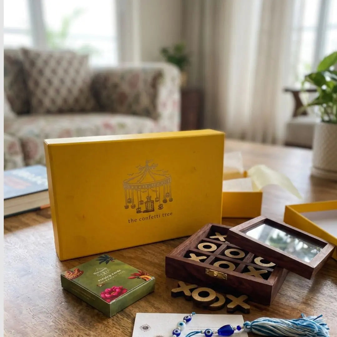 Rakhi Gift Hamper with Evil Eye Rakhi & Lumba, Wooden Tic Tac Toe & Limited Edition Playing Cards | Premium Raksha Bandhan Gift Box for Bhai Bhabhi The confetti tree