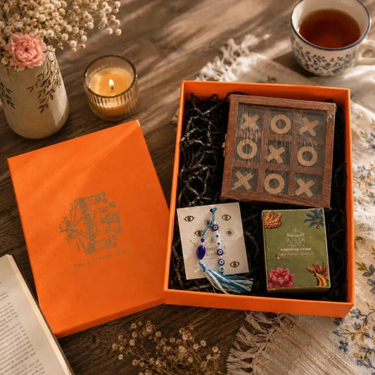 Rakhi Gift Hamper with Evil Eye Rakhi & Lumba, Wooden Tic Tac Toe & Limited Edition Playing Cards | Premium Raksha Bandhan Gift Box for Bhai Bhabhi The confetti tree