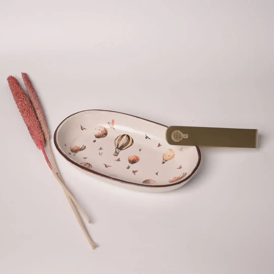 Stoneware Oval Tray with Hot Air Balloon Print & Brass Tong – Whimsical Serveware Set for Snacks, Cookies & Festive Gifting The confetti tree