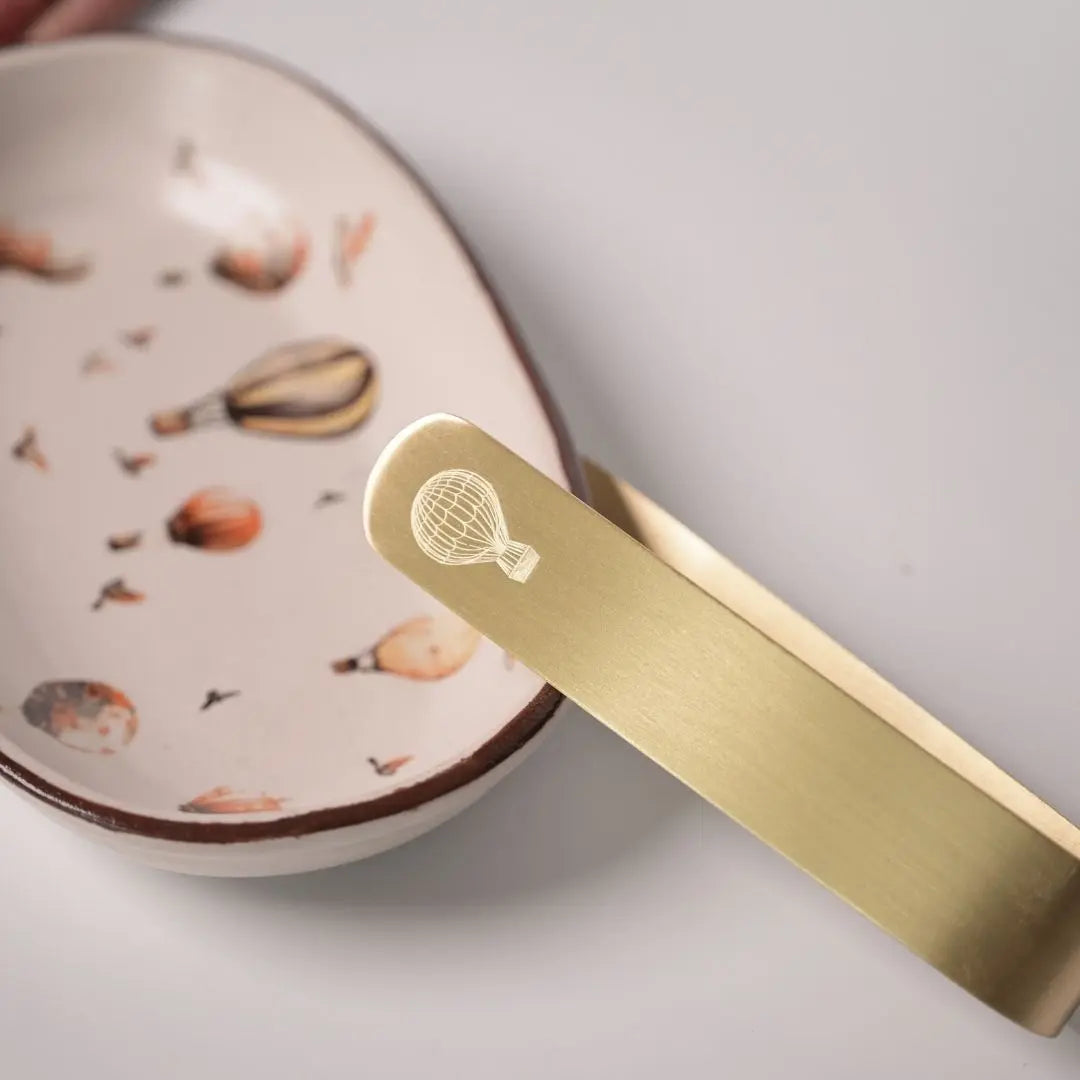 Stoneware Oval Tray with Hot Air Balloon Print & Brass Tong – Whimsical Serveware Set for Snacks, Cookies & Festive Gifting The confetti tree