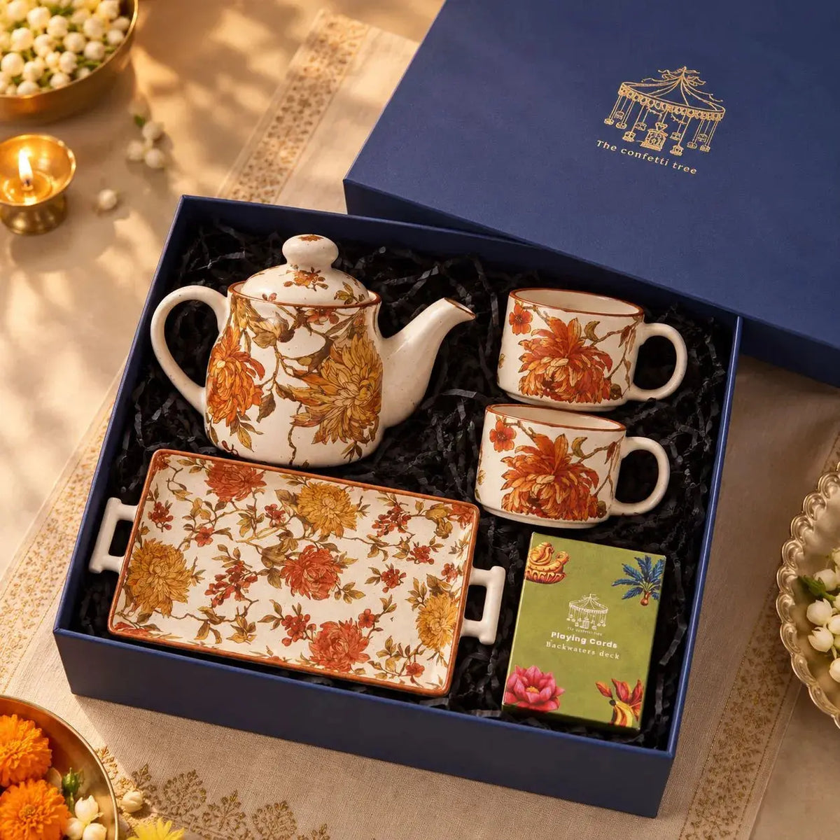 The Autumn Tea Affair Gift Hamper – Diwali Gift Box with Floral Ceramic Teapot, 2 Cups, Serving Tray & Playing Cards The confetti tree